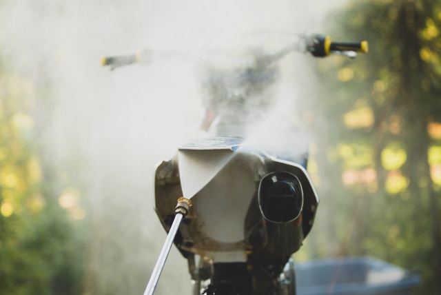 Power washing underneath a motocross bike's subframe