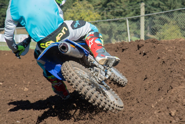 Dirt bike on a Motocross track with close-up fo the exhaust